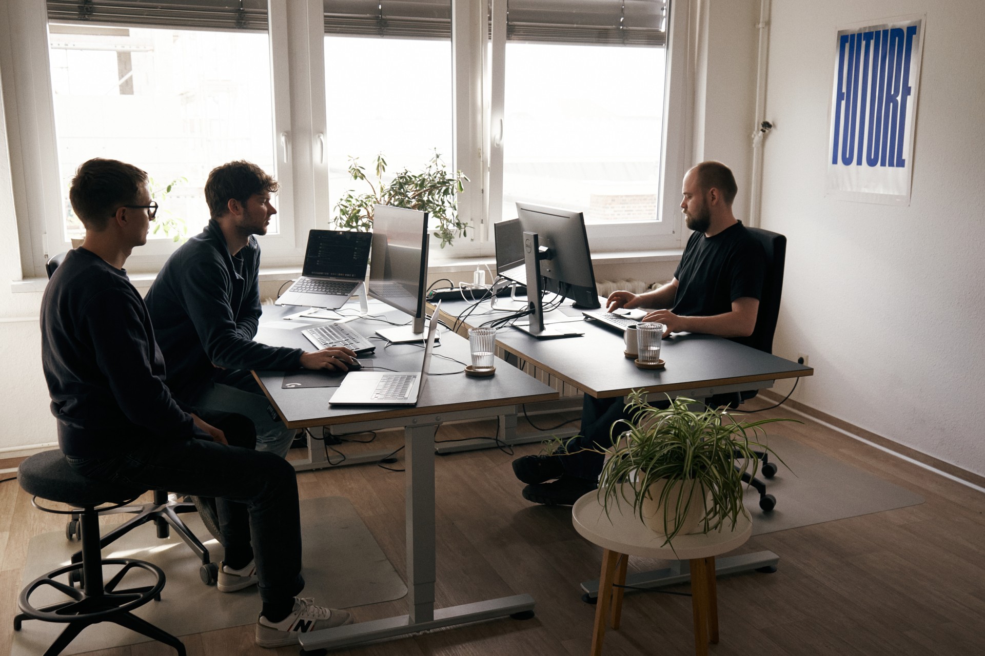 Picture of three developers at their desks