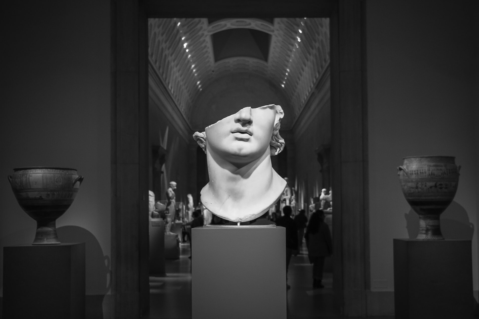 Cover picture: You can see a half white male bust made of marble in a museum.